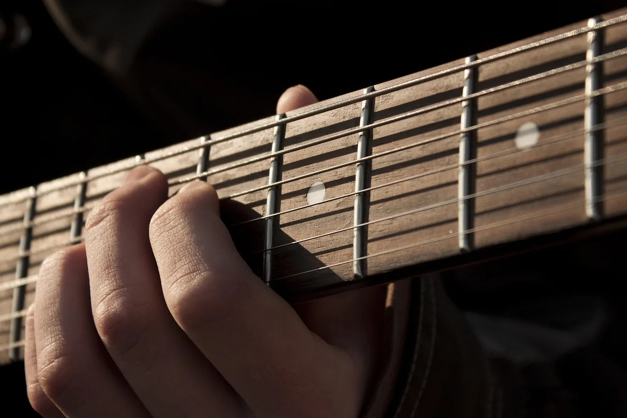 guitarist's hand on the neck guitarist's hand on the neck