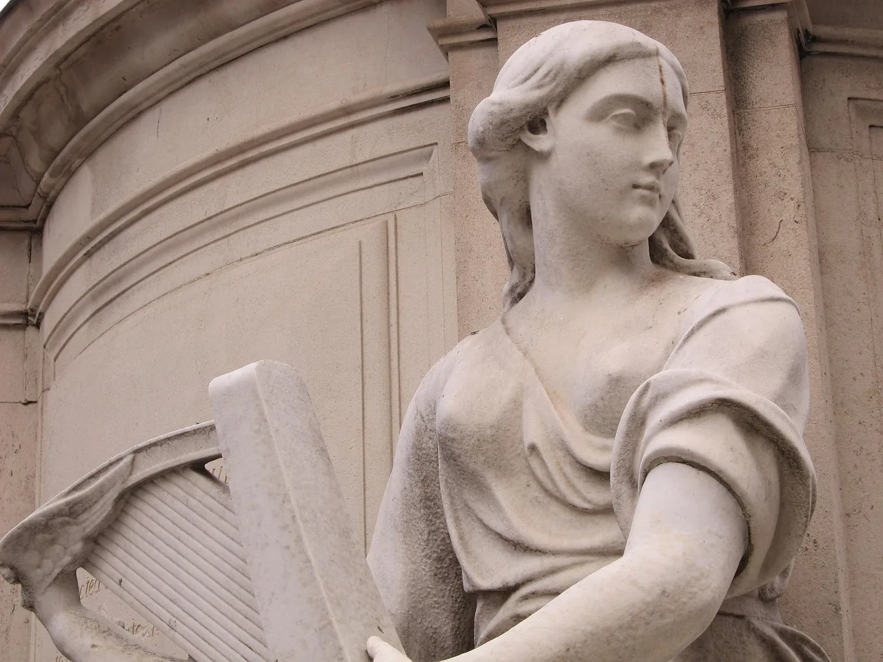 ancient statue holding a harp ancient statue holding a harp