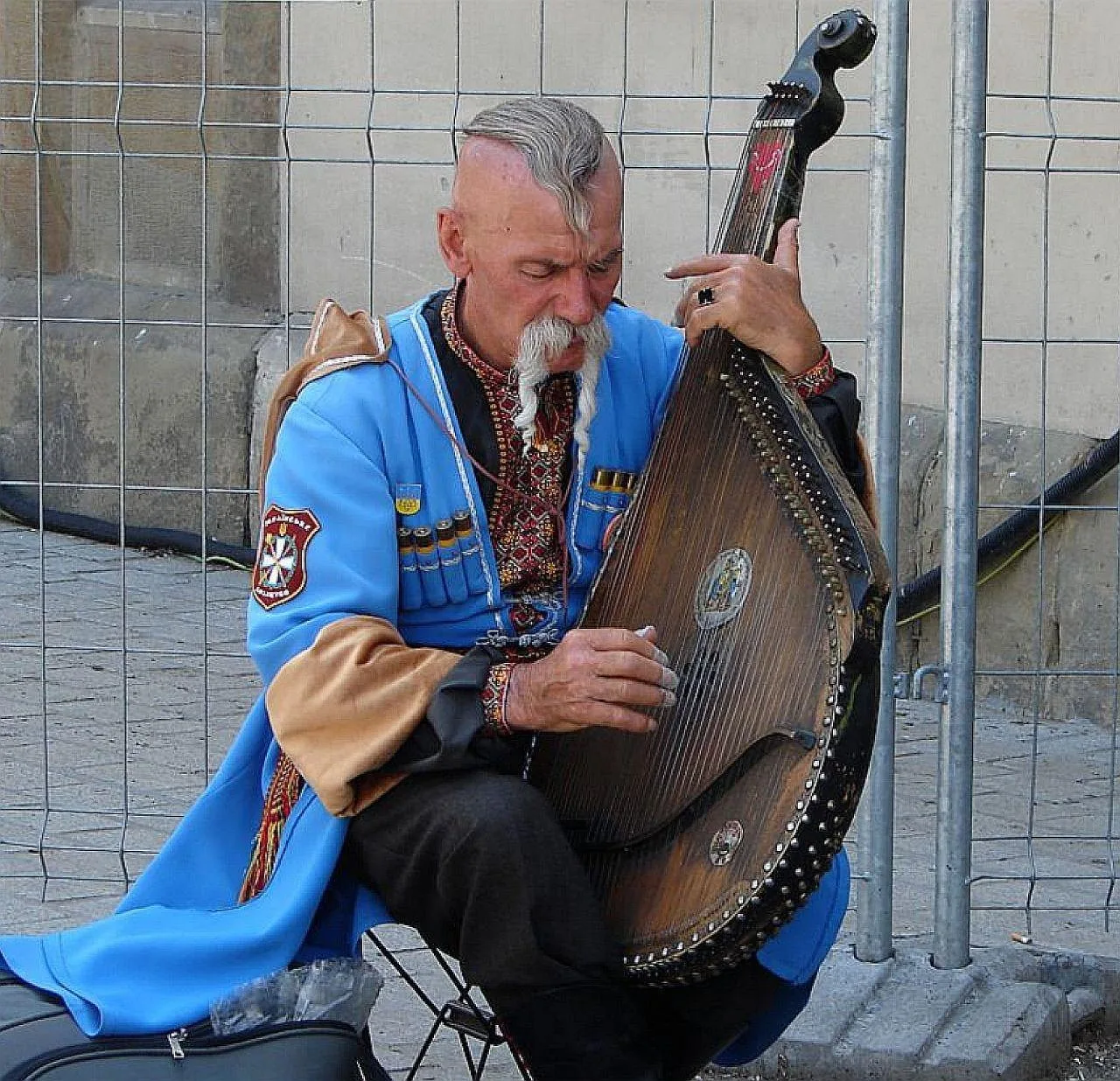 Musician playing a traditional harp Musician playing a traditional harp
