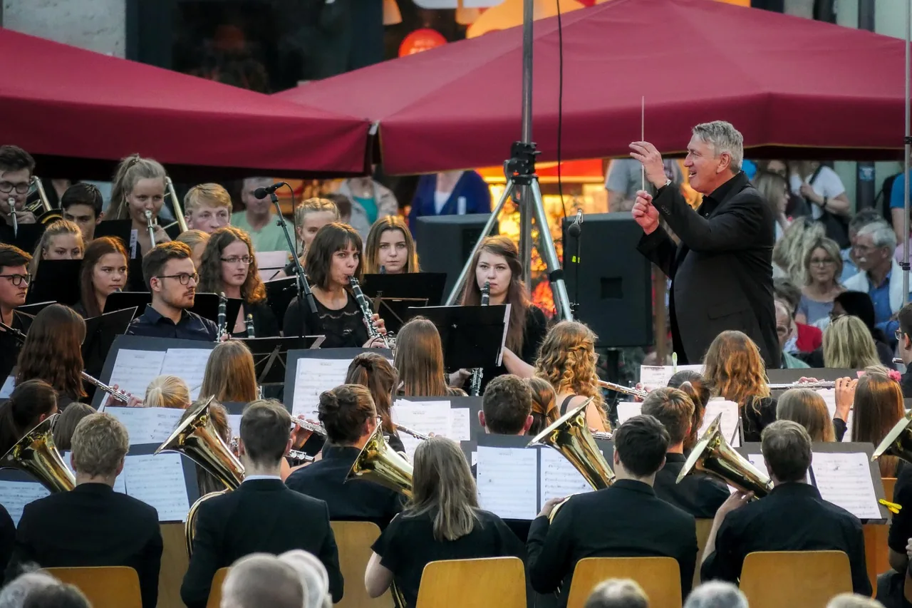 Orchestra in concert under a conductor Orchestra in concert under a conductor