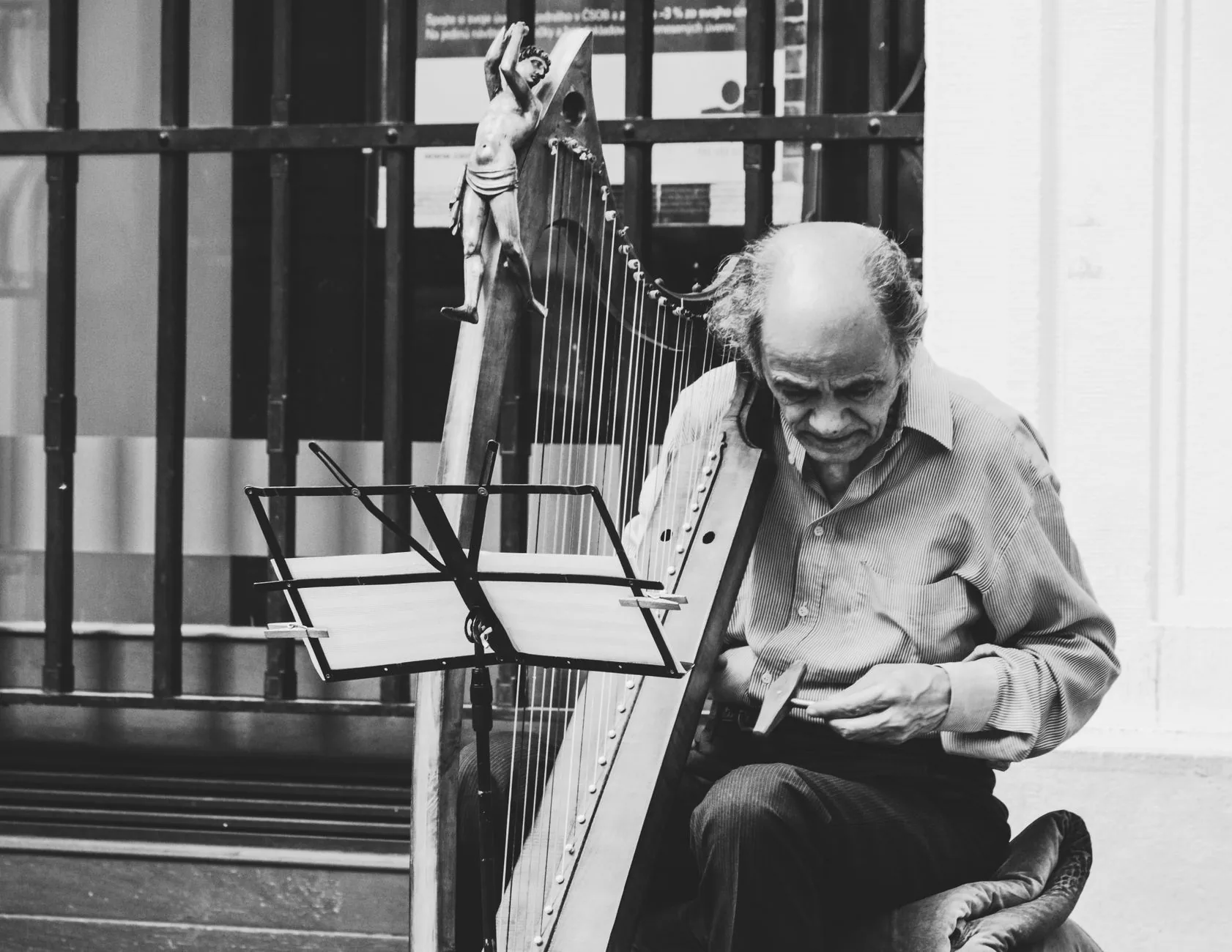 Harpist playing a classical harp Harpist playing a classical harp