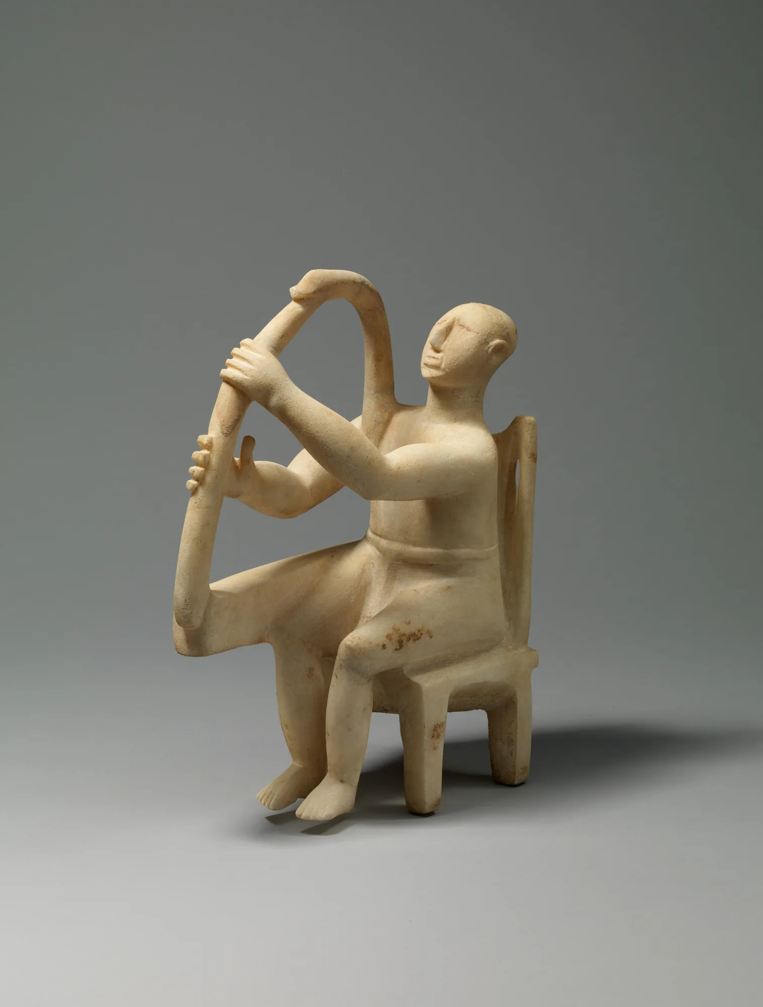ancient statuette of a harp player ancient statuette of a harp player