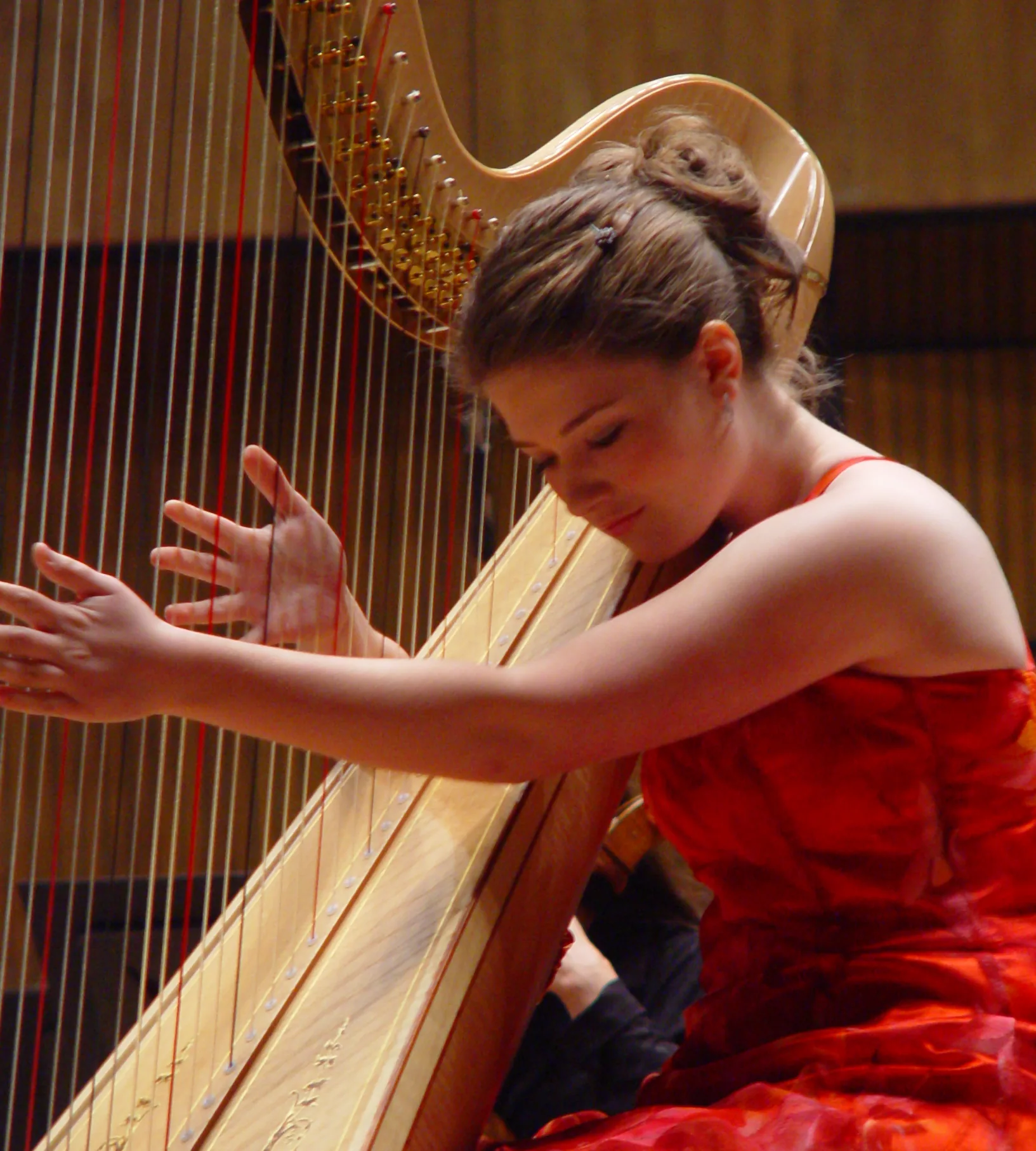 harpist performing in concert with harp harpist performing in concert with harp