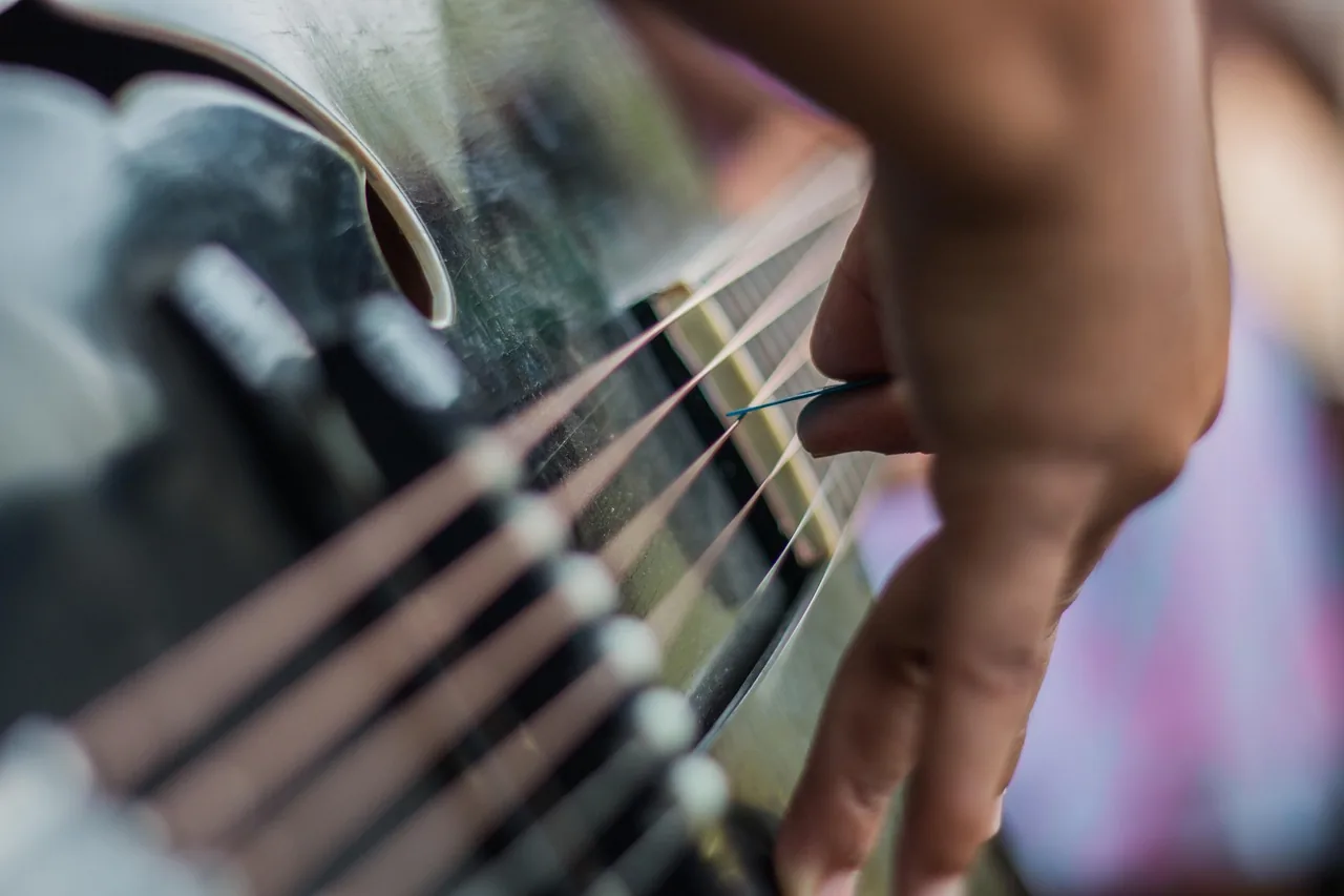 hand playing harp strings hand playing harp strings