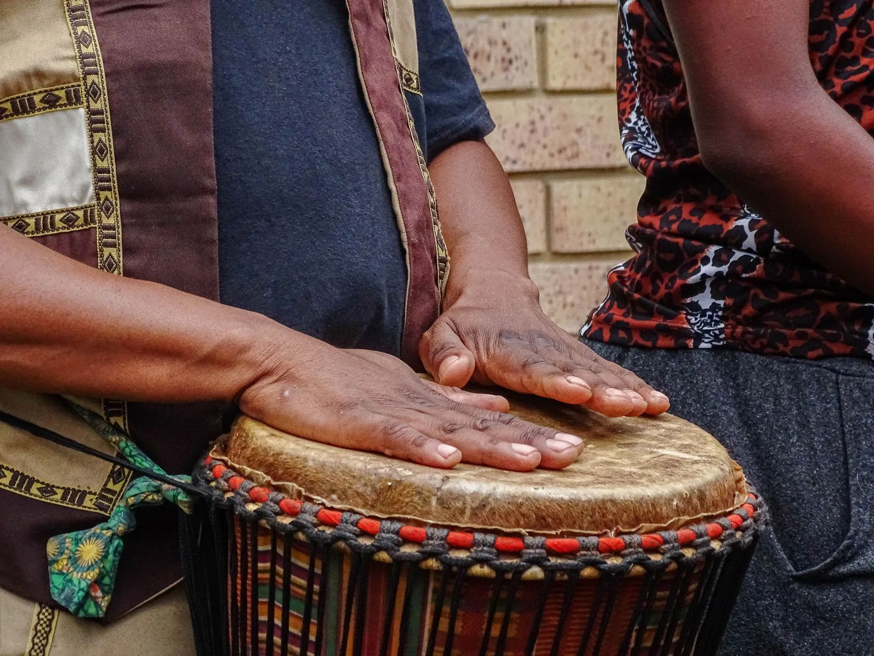 hands playing a large djembe hands playing a large djembe