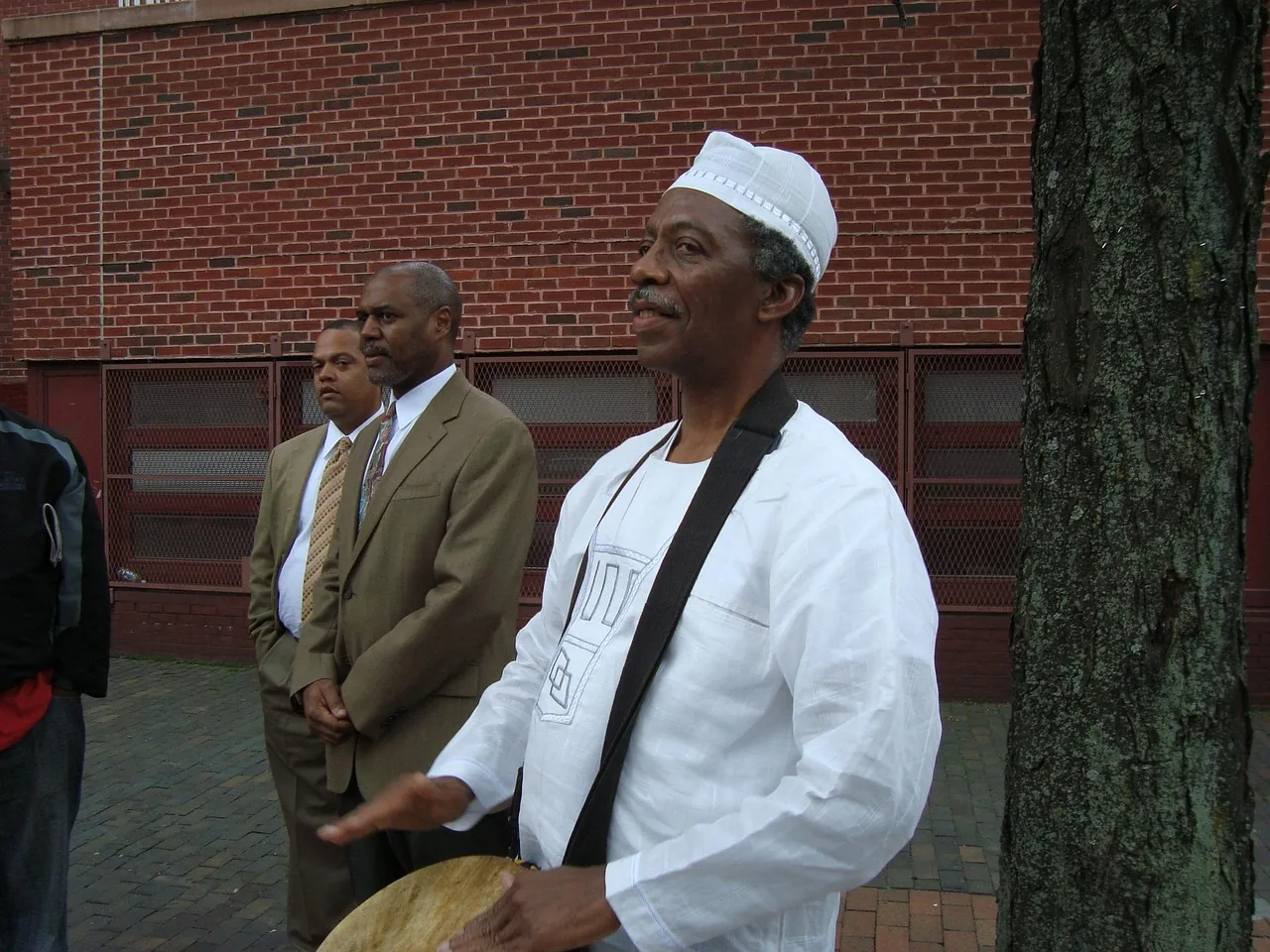musician playing djembe standing musician playing djembe standing