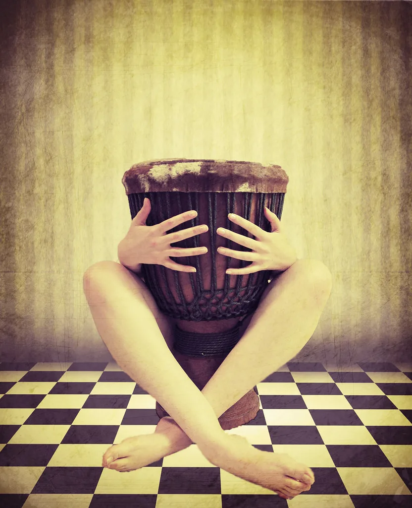 person holding a djembe person holding a djembe