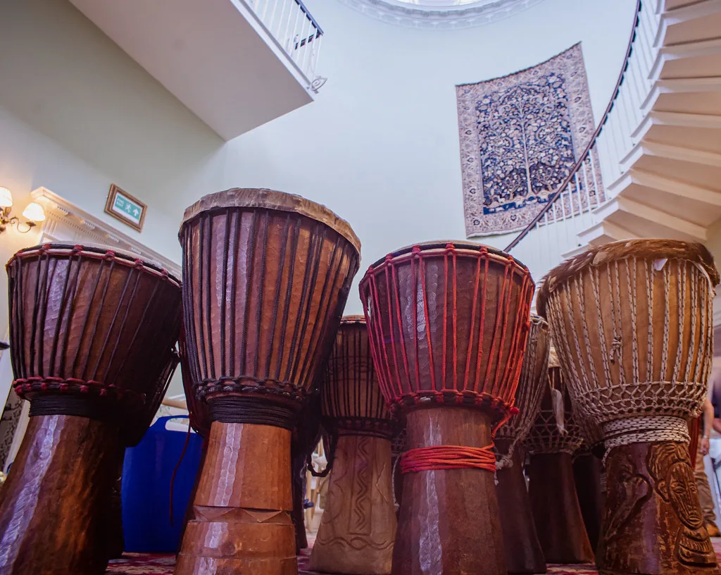 handcrafted djembes displayed indoors