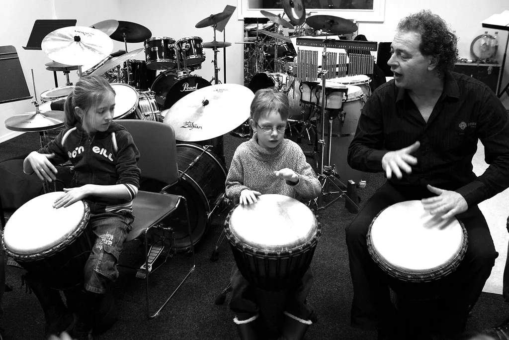Group djembe class indoors Group djembe class indoors