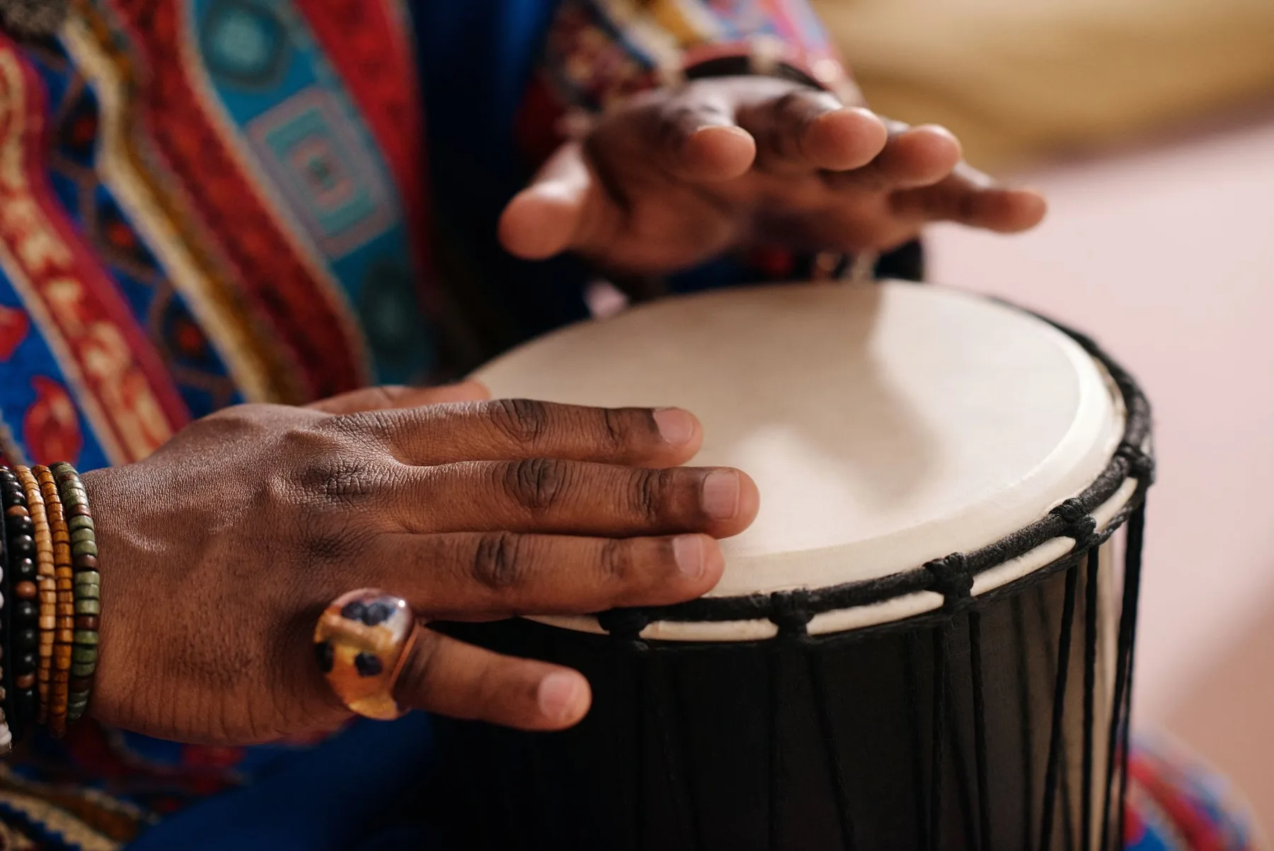 hands playing an African djembe hands playing an African djembe