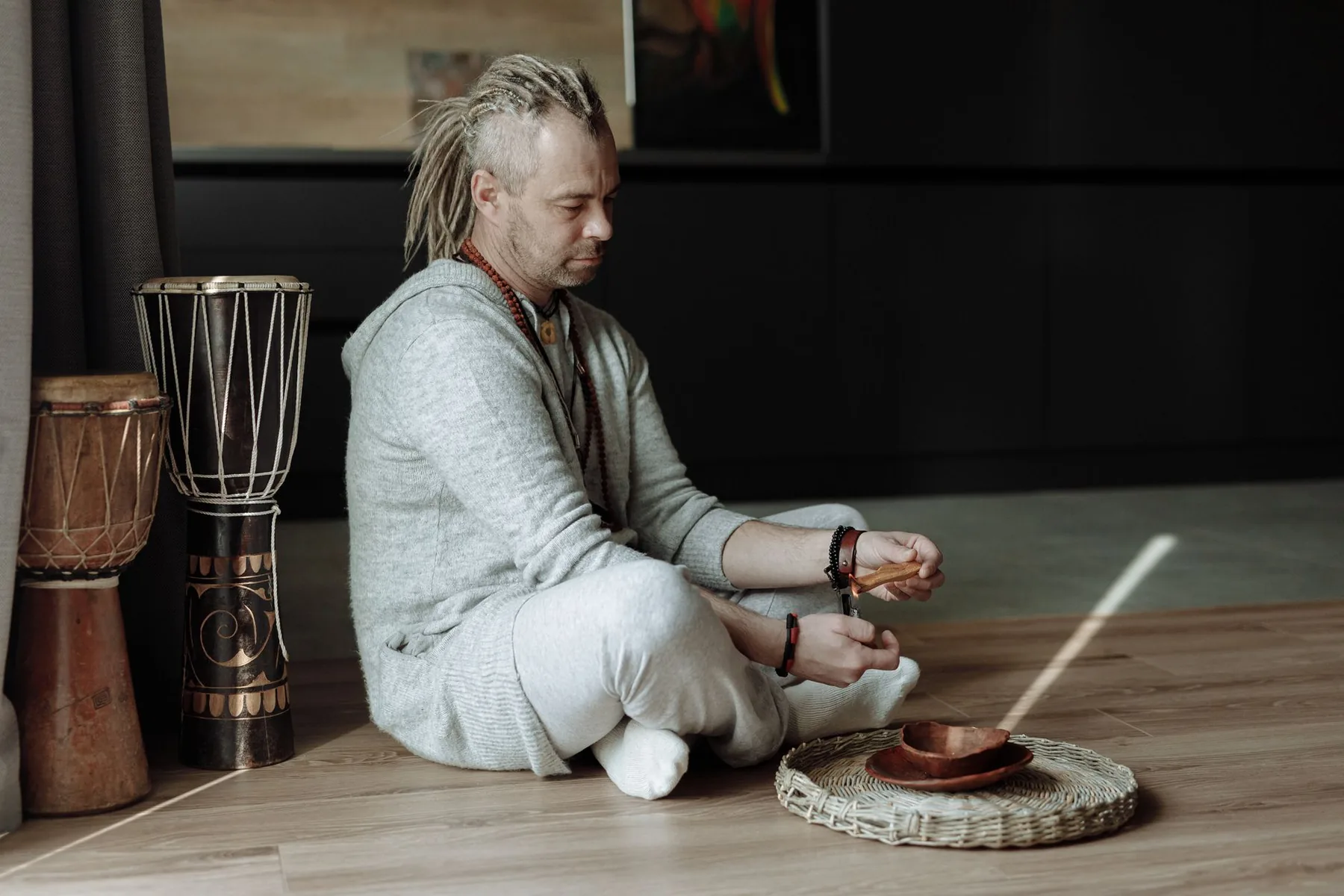 Musician sitting near djembes Musician sitting near djembes