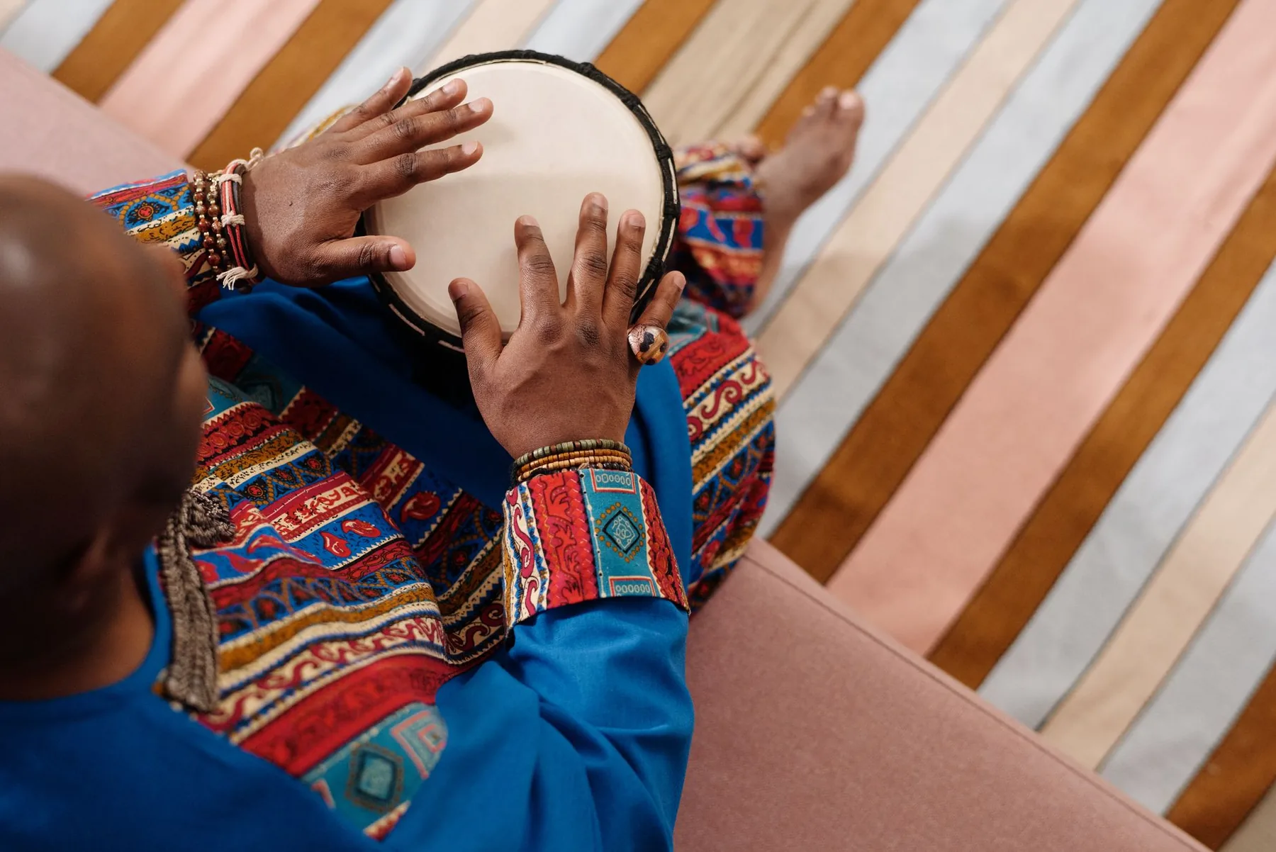hands playing djembe in a workshop hands playing djembe in a workshop